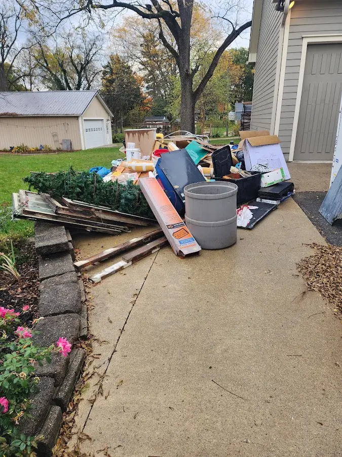 Dumpster being loaded with debris for 10 Yard Dumpster Rental in Ponderosa Park